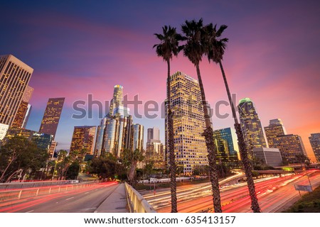 Downtown Los Angeles skyline during rush hour at sunset