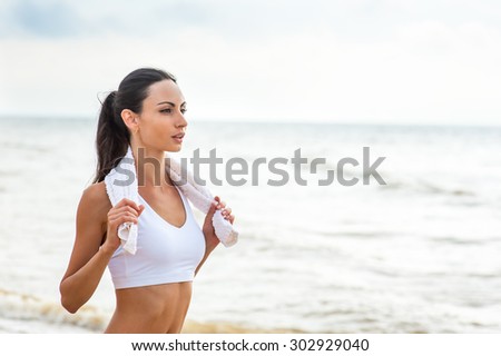 stock photo young woman on beach listening to music in earphones from smart phone mp player smartphone armband 302929040 The Best Way to Approach Virtually any Woman Using a Hot Latina Body