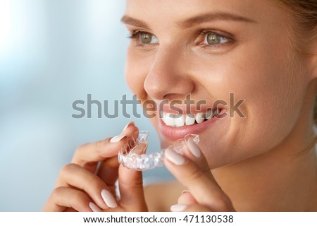 Woman With Healthy Straight White Teeth Holding Teeth Whitening 