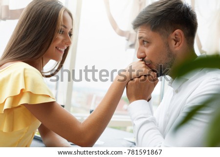 Tips To Find A Partner In The Proper City stock photo beautiful couple in love in restaurant handsome male kissing female hand on romantic date 781591867