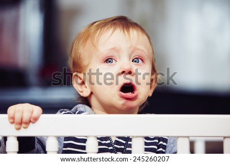 Little boy is crying in the bed