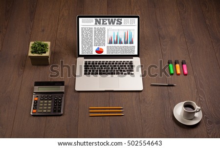 Computer laptop on wooden desk with office accessories 