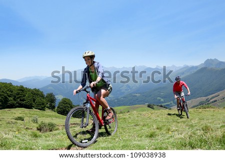 Couple riding bicycles in the mountains
