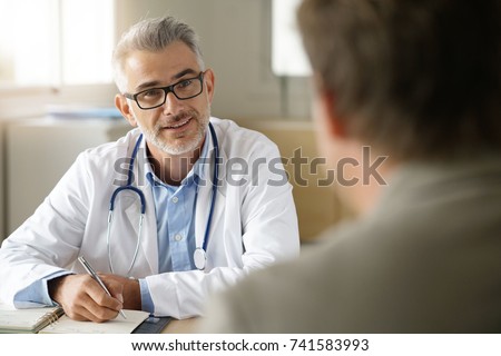 Doctor talking to patient in office
