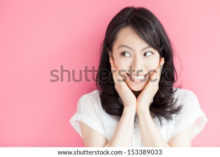 happy young woman against pink background