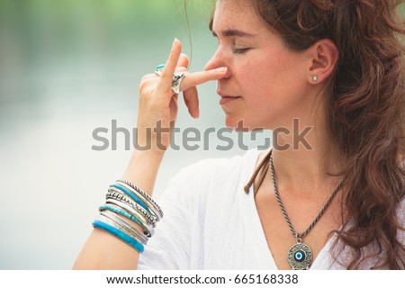 https://thumb1.shutterstock.com/display_pic_with_logo/63906/665168338/stock-photo-young-woman-practice-yoga-breathing-techniques-outdoor-by-the-lake-healthy-lifestyle-concept-665168338.jpg