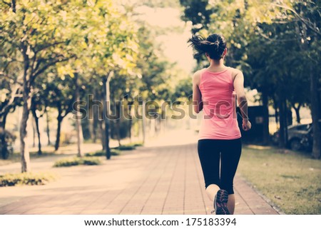 fit sports woman jogging at park