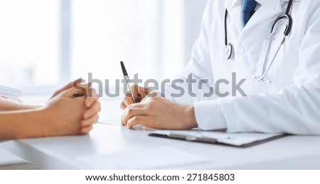close up of patient and doctor taking notes