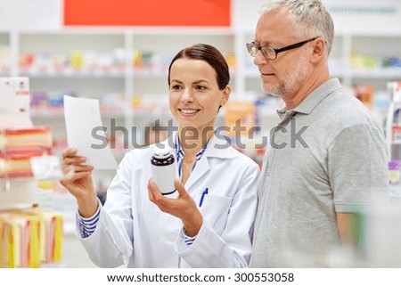 medicine, pharmaceutics, health care and people concept - happy pharmacist and senior man customer with drug and prescription at drugstore