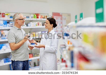 medicine, pharmaceutics, health care and people concept - happy pharmacist giving drug to senior man customer and taking prescription at drugstore