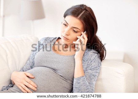 pregnancy, motherhood, technology, people and expectation concept - sad pregnant woman calling on smartphone at home
