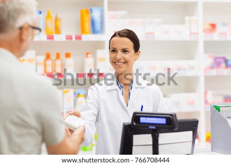 medicine, pharmaceutics, health care and people concept - apothecary and senior man customer buying drug at drugstore