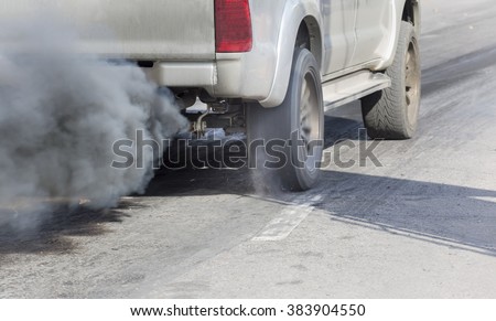 Air pollution from vehicle exhaust pipe on road