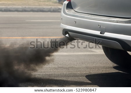 Air pollution from vehicle exhaust pipe on road