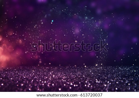 glitter vintage lights background. gold, purple and black. de-focused.