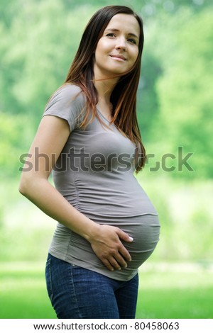 Young beautiful pregnant woman with long dark hair.