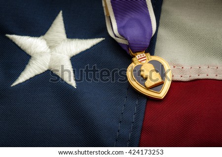 The Purple Heart is a United States military decoration awarded in the name of the President to those wounded or killed while serving and the american flag