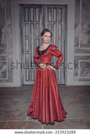 https://thumb1.shutterstock.com/display_pic_with_logo/649624/215923288/stock-photo-beautiful-young-woman-in-red-long-medieval-dress-215923288.jpg