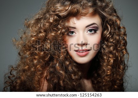 Young beautiful woman with long curly hairs