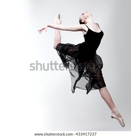 Beautiful ballet-dancer, modern style dancer posing on studio background