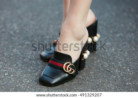 MILAN - SEPTEMBER 22: Woman with Gucci shoes with pearl decoration before Prada fashion show, Milan Fashion Week street style on September 22, 2016 in Milan.
