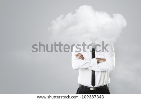 Young businessman with head in the clouds