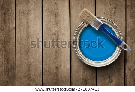 House renovation, paint can on the old wooden background with copy space
