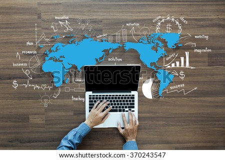 World map with creative thinking drawing charts and graphs business success strategy plan ideas, With Man hand working on laptop computer keyboard with blank screen monitor, Top View
