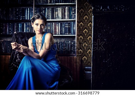https://thumb1.shutterstock.com/display_pic_with_logo/67164/316698779/stock-photo-elegant-lady-wearing-evening-dress-sitting-in-the-chair-in-the-old-vintage-library-beauty-fashion-316698779.jpg