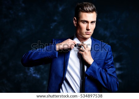 Fashion shot of a handsome young man in elegant classic suit. Men's beauty, fashion.