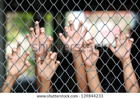 children's hand in jail.