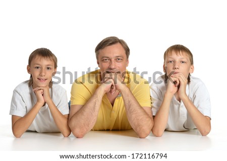 Father with sons on the floor smiling into camera