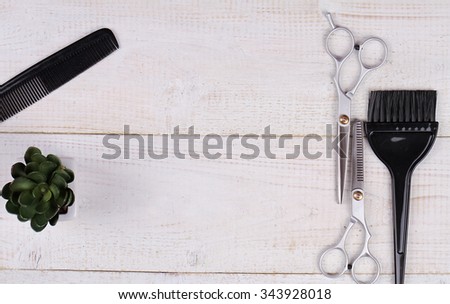 Stylish Professional Barber Scissors, Hair Cutting and Thinning Scissors, comb and brush for hair coloring on white wooden background. Hairdresser salon concept. Haircut accessories, flat lay