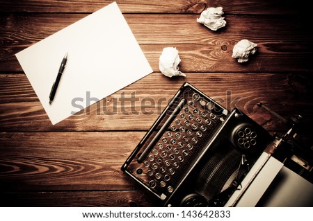 Vintage typewriter and a blank sheet of paper, retouching retro