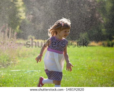Happy little girl running away from rain