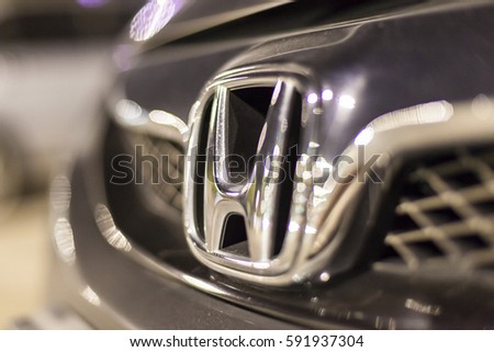 ABU DHABI, UAE - NOV 26, 2016: Honda company logo on a car illuminated at night