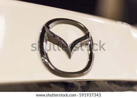 ABU DHABI, UAE - NOV 26, 2016: Mazda company logo on a car illuminated at night