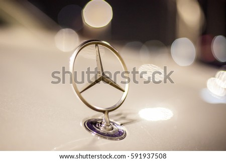 ABU DHABI, UAE - NOV 26, 2016: Mercedes Benz company logo on a car illuminated at night