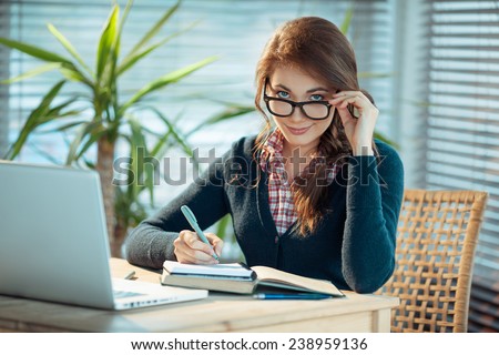 stock-photo-young-woman-in-glasses-studying-238959136.jpg
