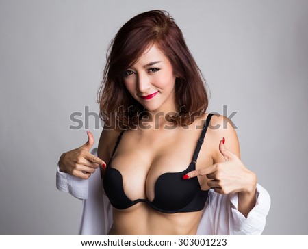 https://thumb1.shutterstock.com/display_pic_with_logo/699607/303001223/stock-photo-sexy-asian-woman-showing-her-sexy-breast-in-black-bra-or-lingerie-with-shirt-opened-and-pointing-303001223.jpg