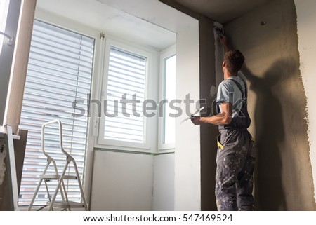 construction worker wearing worker overall with wall plastering tools renovating apartment house plasterer renovating indoor - Wall Plastering Designs construction worker wearing worker overall with wall plastering tools renovating apartment house plasterer renovating indoor - Wall Plastering Designs