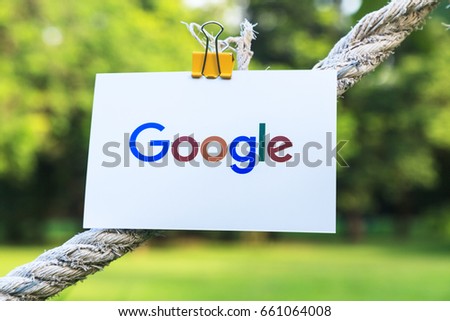 Bangkok, Thailand - June 15, 2017: Google logo sign printed on paper hanging on a rope in the park. Google it is the largest Internet search engine.