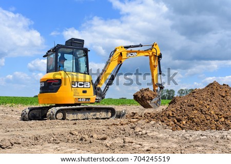 Kalush, Ukraine- June 15, 2017: The modern excavator JCB performs excavation work on the construction site near the city of Kalush, Western Ukraine.