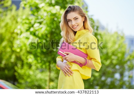 https://thumb1.shutterstock.com/display_pic_with_logo/71188/437822113/stock-photo-beautiful-blonde-young-woman-wearing-yellow-dress-walking-on-the-street-437822113.jpg