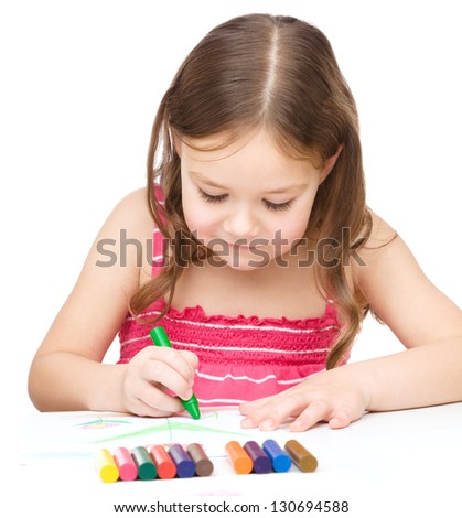 little girl is drawing using colorful crayons while sitting at table isolated over white - Little Kid Coloring little girl is drawing using colorful crayons while sitting at table isolated over white - Little Kid Coloring