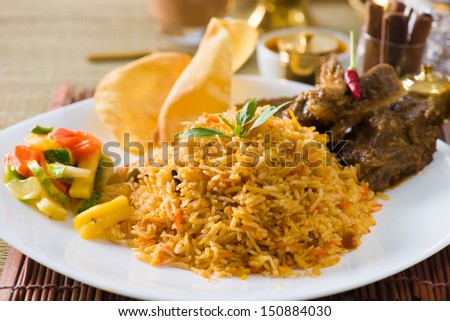 Biryani mutton rice papadam with traditional background - stock photo