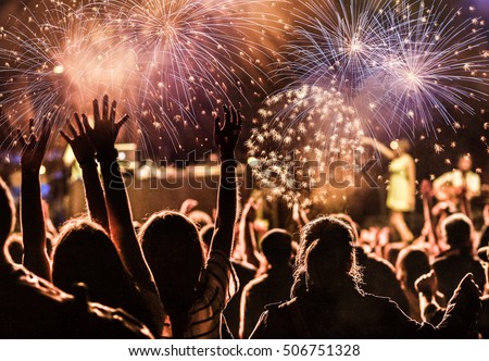 New Year concept - cheering crowd and fireworks