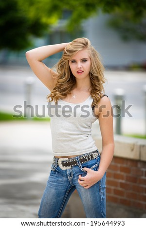 stock photo beautiful and young blonde girl in tank top and jeans 195644993
