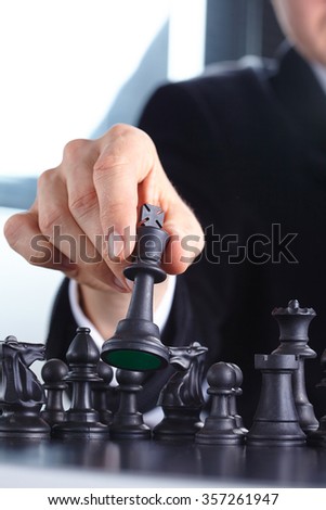 businessman playing chess game