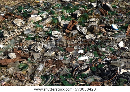 Nature contaminated by glass metal plastic waste
Discarded household garbage on the meadow
Environmental pollution and ecology problem concept.
Human health hazard concept.